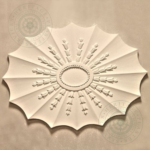CR10 Adams Design Ceiling Rose is a small oval plaster rose with open flutes overlaid with leaf enrichment with plain central boss.