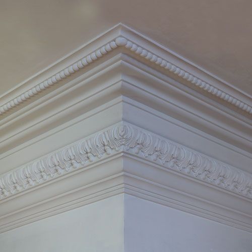 HPS95 Enriched Cornice "MV" is a large fibrous plaster moulding with a bead design to the top member and an intricate leaf and acorn border to the wall line. Separated by a series of cyama recta, cyma reversa, cavetto and plain fillet segments.